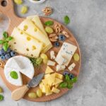 Cheese,Plate,With,A,Variety,Of,Cheeses,,Honey,,Grapes,,Nuts,