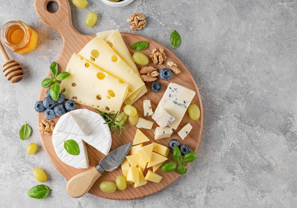 Cheese,Plate,With,A,Variety,Of,Cheeses,,Honey,,Grapes,,Nuts,