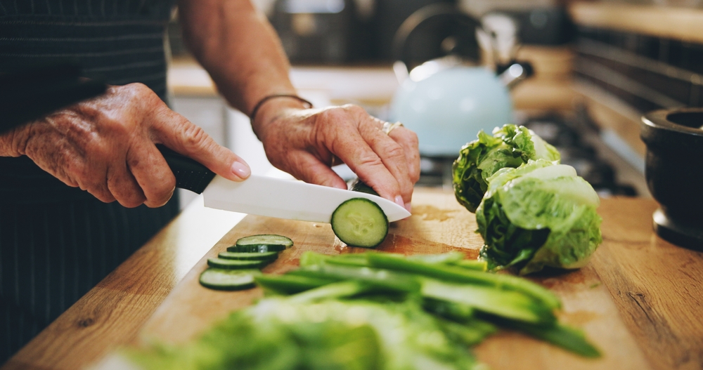 Hands,,Cutting,Board,And,Salad,In,Kitchen,With,Green,Vegetables