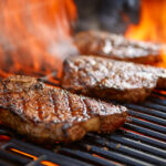 Grilling,Steaks,On,Flaming,Grill,And,Shot,With,Selective,Focus