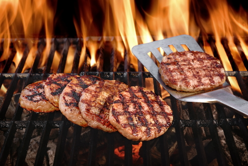 Beef,Burgers,And,Spatula,On,The,Hot,Flaming,Bbq,Charcoal