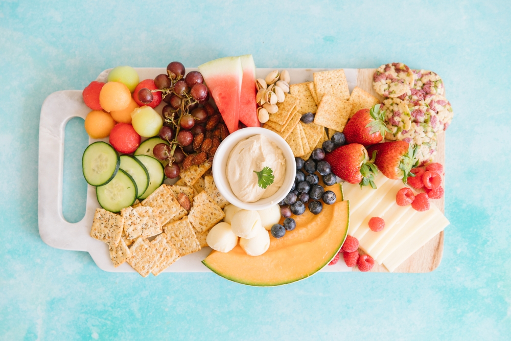 A,Bright,Charcuterie,Board,On,A,Blue,Background.,On,The