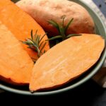 Fresh,Raw,Sweet,Potatoes,And,Rosemary,In,Bowl,On,Dark