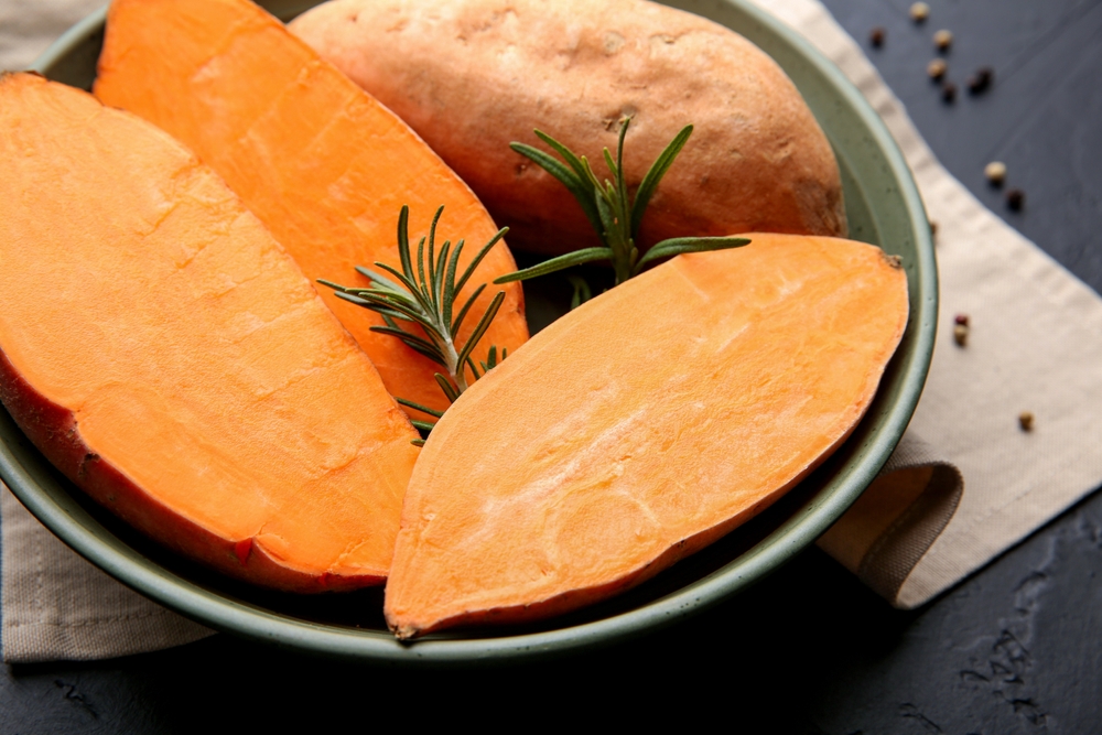 Fresh,Raw,Sweet,Potatoes,And,Rosemary,In,Bowl,On,Dark